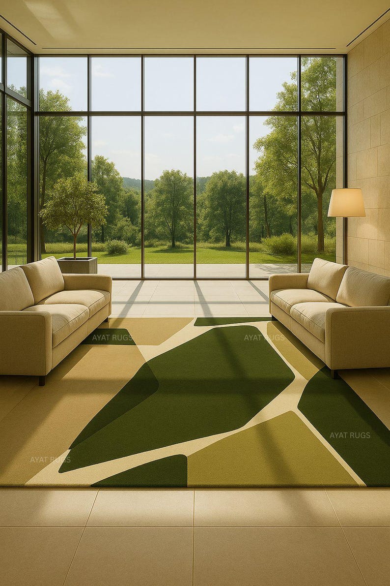 May include: A modern living room with two beige sofas facing a large window overlooking a green landscape. A geometric rug in shades of green and beige covers the floor. The text "AYAT RUGS" is visible on the rug.