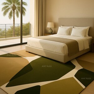 May include: A modern bedroom with a large area rug featuring an abstract design in shades of green, beige, and white. The rug is placed in front of a bed with white linens and a neutral-toned headboard. A large window offers a view of a palm tree.