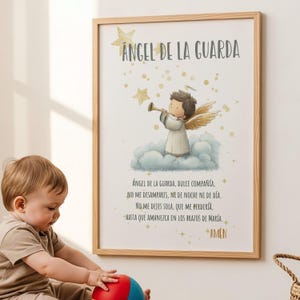 May include: A framed print featuring an illustration of an angel playing a trumpet, set against a backdrop of clouds and stars. The text "ANGEL DE LA GUARDA" is at the top, with a prayer below. The frame is made of light-colored wood.
