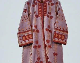 May include: A long, lavender coat with intricate embroidery. The coat features a mandarin collar, long sleeves, and a floor-length design. The embroidery is in shades of red and gold, with floral and geometric patterns.