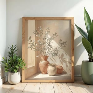 May include: A framed art print depicting a still life of vases and olive branches. The artwork features a large terracotta vase with smaller neutral-toned vases. The print is in a light wooden frame, with a neutral background.