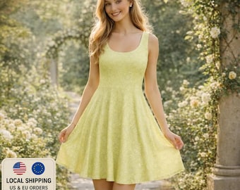 May include: A light yellow, sleeveless dress with a floral pattern. The dress has a scoop neckline and a flared skirt. The woman is standing in a garden setting with flowers and greenery in the background.