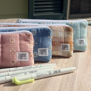 May include: A rustic wooden sign with the text "Welcome to our home" in white lettering. The sign features a distressed finish and a simple, inviting design, perfect for entryway decor.