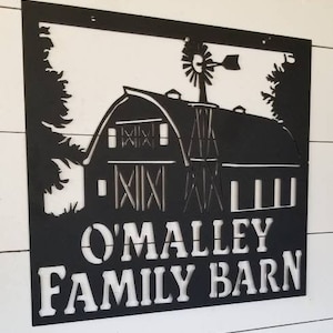 May include: Black metal sign with a silhouette of a barn and windmill. The sign reads "O'Malley Family Barn".