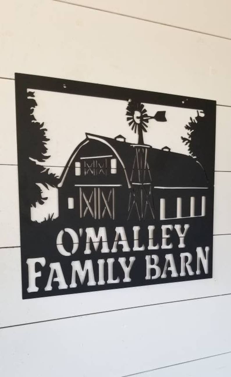 May include: Black metal sign with a silhouette of a barn and windmill. The sign reads "O'Malley Family Barn".