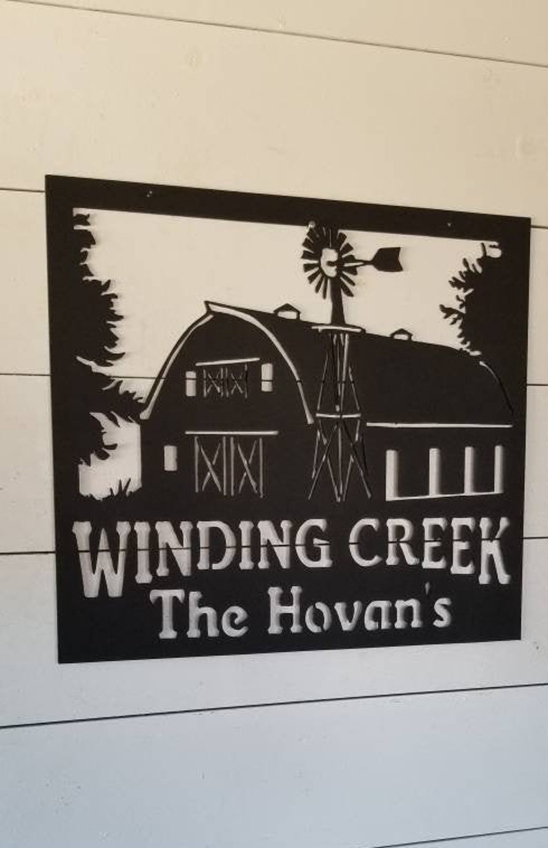 May include: Black metal sign with a white silhouette of a barn, windmill, and trees. The sign reads "Winding Creek The Hovan's".
