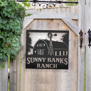 May include: Black metal sign with a silhouette of a barn and windmill, with the text "Sunny Banks Ranch" underneath.
