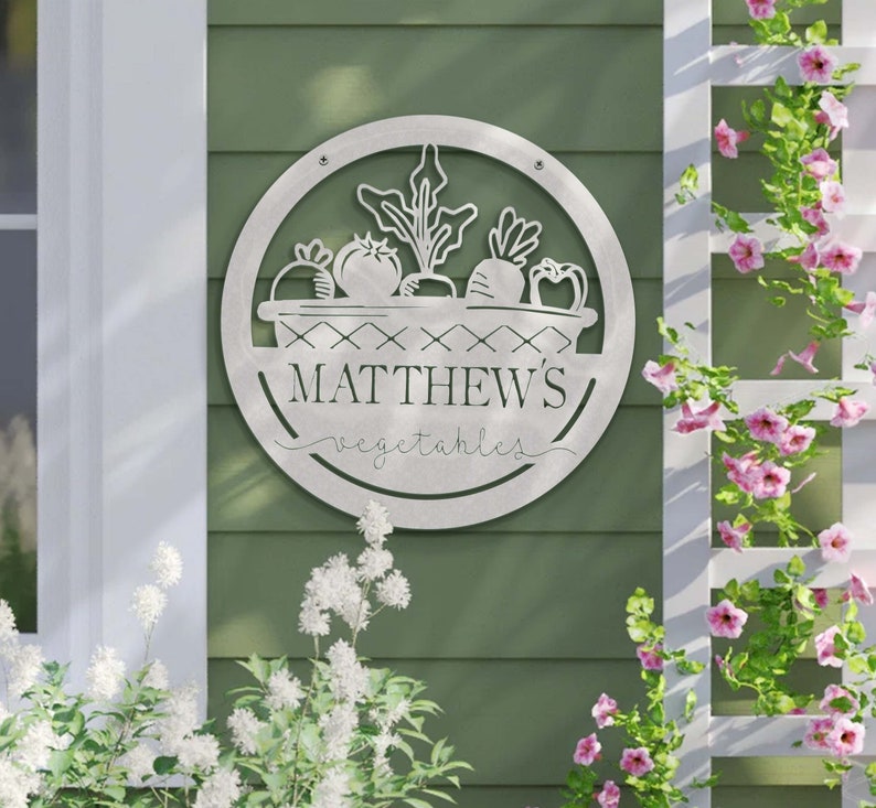 May include: A metal garden sign with a basket of vegetables and the text "MATTHEW'S vegetables".