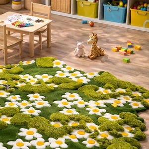 May include: A green rug with white daisy flowers and moss-like patches. The rug is in a child's playroom with a small wooden table and chairs, toys, and storage bins. A stuffed giraffe and a stuffed bunny are on the floor.