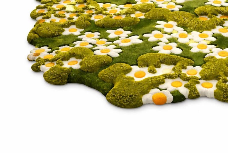 May include: A whimsical rug featuring a field of white daisies with yellow centers and green foliage. The rug has a textured, three-dimensional design, creating a playful and inviting aesthetic. The rug's shape is irregular, adding to its unique charm.