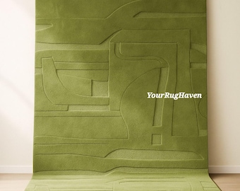 May include: A large, rectangular green rug with a raised, abstract design. The rug features a series of geometric shapes and lines, creating a textured surface. The text "YourRugHaven" is visible on the rug.