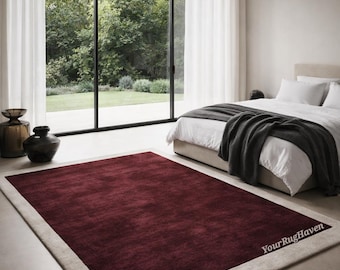 May include: A rectangular area rug featuring a deep burgundy center panel framed by a wide, light beige border. The rug has a soft, plush texture and includes the text YourRugHaven printed in white on the lower right corner.