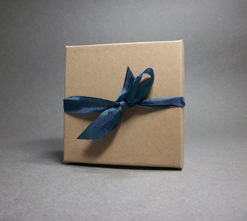 May include: A brown gift box with a blue ribbon tied in a bow.