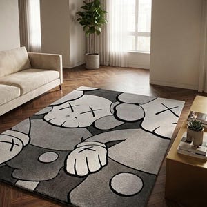KAWS inspired hand tufted New Zealand wool rug in grey, black and ivory tones, modern pop art area rug styled in a luxury contemporary living room with designer furniture.