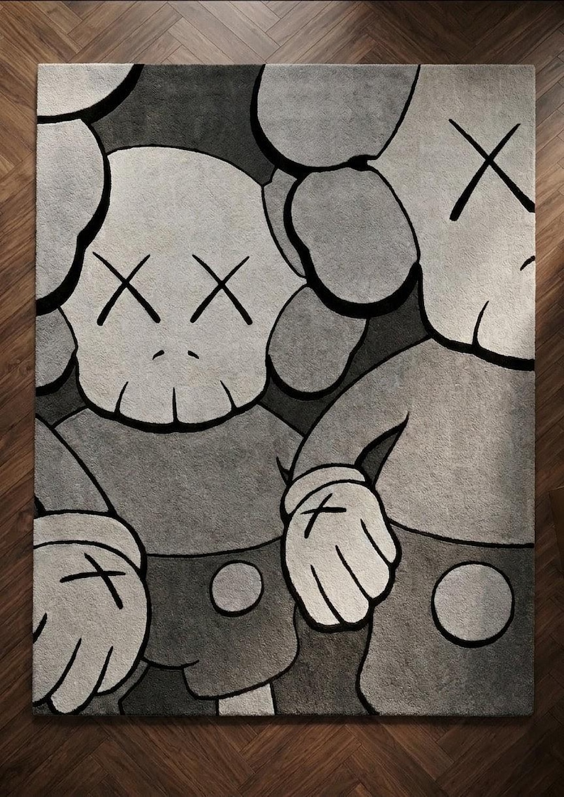 K&ouml;nnte beinhalten: Ein rechteckiger Teppich mit einer grafischen Illustration von zwei Zeichentrickfiguren mit totenkopfartigen K&ouml;pfen, X-f&ouml;rmigen Augen und behandschuhten H&auml;nden. Das Design ist in Grau-, Schwarz- und Wei&szlig;t&ouml;nen mit kr&auml;ftigen schwarzen Konturen gehalten.