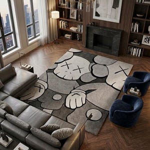 A large 8x10 foot hand-tufted New Zealand wool rug featuring a KAWS style pop art character in grey and slate blue tones on a dark wood chevron floor in a luxury modern living room setting.