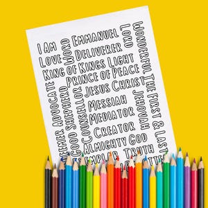 May include: A white sheet with black text listing various names and titles, including "I AM," "Love," and "Jesus Christ." The sheet is propped up by a collection of colorful pencils against a bright yellow background. The pencils are arranged in a rainbow spectrum.