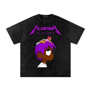 May include: Black t-shirt featuring a cartoon graphic of a character with purple hair and a person lying on top. The text "ILUZIVER VS THE WORLD" is printed in purple above the character.