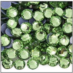 May include: A collection of round, faceted light green rhinestones with a brilliant cut. Each stone features a flat back and a reflective surface, creating a dense cluster of sparkling, circular embellishments in a uniform lime green hue.