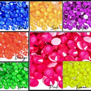 May include: A collection of colorful, faceted rhinestones in various shades. The image displays rhinestones in blue, yellow, purple, orange, pink, green, and yellow-green. Each color is labeled with a handwritten script font.