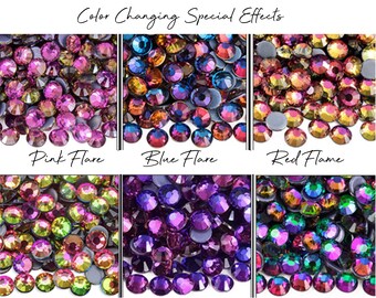 May include: Close-up of six different color variations of chameleon effect rhinestones. The colors include Pink Flare, Blue Flare, Red Flame, Rainbow, Purple Velvet, and Green Volcano. The text "Chameleon Color Changing Special Effects" is at the top.