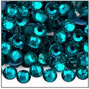 May include: A close-up view showcases a collection of teal-colored rhinestones. Each rhinestone has a faceted surface, reflecting light and creating a sparkling effect. The gems are round with a flat back, suitable for various craft projects.
