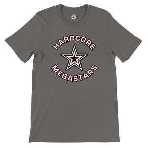 May include: A gray t-shirt featuring a graphic with the text "HARDCORE MEGASTARS" in a circular design around a star. The star is white with a black center and pink outline. The shirt has a crew neck.