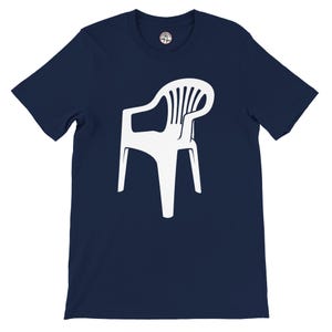 May include: A navy blue t-shirt with a white graphic of a plastic garden chair. The chair is illustrated in a minimalist style. The t-shirt has short sleeves and a crew neck. A small logo is visible on the upper left chest.