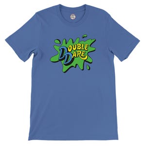 May include: A blue t-shirt with the words "DOUBLE DARE" in a green, yellow, and blue graphic. The design resembles a paint splash. The shirt has short sleeves and a crew neck.