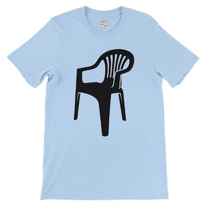 May include: Pale blue t-shirt with a black graphic of a plastic chair. The chair is depicted in a simple, graphic style. The t-shirt has short sleeves and a round neckline.
