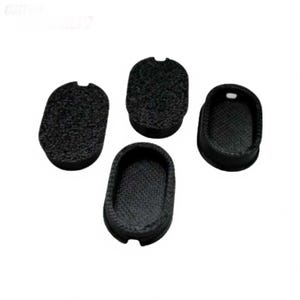 May include: Four black, oval-shaped, textured objects with a small notch on one end. One object is a solid oval, while the other three have a hollowed-out interior. The objects are arranged on a white background.