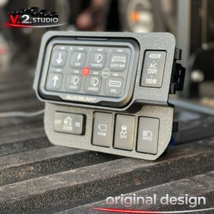 May include: A black control panel with multiple illuminated buttons, including "AUX", "BUMPER", and "LIGHT BAR". The panel also features the text "AUXBEAM" and "400W AC 120V 100W". The words "original design" are at the bottom.