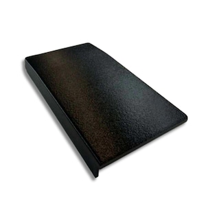 May include: A black, rectangular object with a textured surface. The object has a slightly raised edge on one side, and is angled towards the viewer. The item is set against a white background.