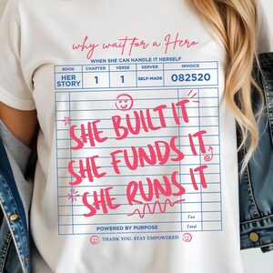 May include: White t-shirt with the text "why wait for a Hero" and "She Built It, She Funds It, She Runs It" in pink. The design includes a mock invoice with the words "Her Story" and "Self-Made".