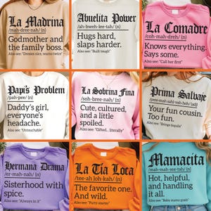 Latina definition sweatshirt bundle featuring 9 funny and sassy designs with bold black text on colorful crewnecks. Includes La Madrina, Abuelita Power, La Comadre, Papi’s Problem, La Sobrina Fina, Prima Salvaje, Hermana Drama, La Tia Loca, and Mamacita. Perfect for Hispanic pride apparel, Latina gifts, and humorous family sweatshirts.