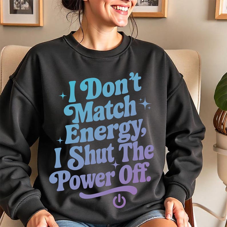 Black sweatshirt featuring colorful blue-to-purple gradient text “I Don’t Match Energy…” styled in trendy retro font, worn by smiling woman – perfect for showcasing sassy digital download.