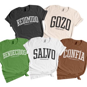 Group mockup displaying multiple unisex Christian t-shirts in assorted colors, each featuring bold Spanish faith words such as GOZO, SALVO, CONFÍA, BENDECIDOS, and REDIMIDO with corresponding Bible verses. The shirts are arranged neatly on a white background, highlighting color variety, distressed varsity typography, and cohesive Christian design themes. This mockup is ideal for showcasing faith-based apparel collections, Spanish Bible verse shirts, and inspirational clothing bundles.