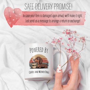 May include: White ceramic mug with the text "POWERED BY" and a cartoon dachshund dog with a coffee cup. The mug also says "COFFEE AND WIENER DOGS". The image includes the text "SAFE DELIVERY PROMISE!"