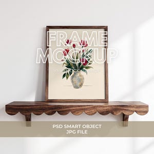 May include: A dark wood picture frame containing a print of a vase with red flowers and green leaves. The frame rests on a dark wood scalloped shelf. The text FRAME MOCKUP BY KEMOCKUPSHOP and PSD SMART OBJECT JPG FILE is visible on the image.