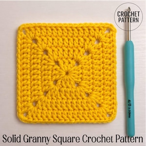 May include: A bright yellow solid granny square crochet pattern. The square is made of yarn and has a central floral design. A crochet hook with a blue handle is next to the square. Text reads "Crochet Pattern" and "Solid Granny Square Crochet Pattern".