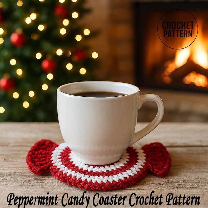 May include: A white ceramic mug filled with coffee sits on a red and white peppermint candy-shaped crochet coaster. The coaster is handmade and has a circular design. The text "Peppermint Candy Coaster Crochet Pattern" is at the bottom.
