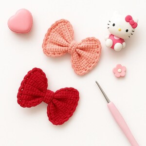Pu&ograve; includere: Due fiocchi all'uncinetto, uno rosa chiaro e uno rosso scuro, sono disposti insieme a un macaron rosa a forma di cuore, una piccola statuetta di Hello Kitty, un minuscolo ciondolo a forma di fiore rosa e un uncinetto rosa chiaro su sfondo bianco.