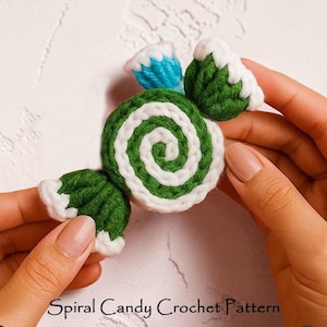 May include: A handmade crochet candy in green and white spiral design with blue and white accents. The candy is held in a person's hands. The text "Spiral Candy Crochet Pattern" is at the bottom of the image.