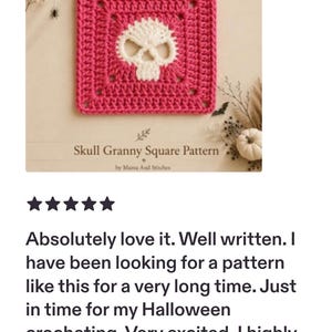 May include: A square crochet piece featuring a white skull motif centered on a vibrant pink background. The text below reads Skull Granny Square Pattern by Mama And Stitches. The design is a flat, hand-stitched textile square with a distinct skull shape.
