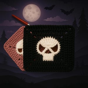 May include: Two square crochet coasters featuring a central white skull motif. One coaster is black and the other is a dusty rose color. A red crochet hook is positioned at the top corner of the black coaster, which is layered over the rose one.