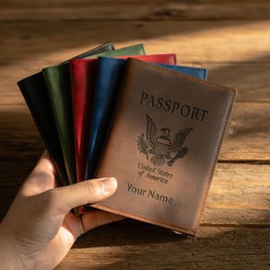 May include: A set of three ceramic mugs with a speckled, matte finish. Each mug features a different color: light blue, cream, and gray. The mugs have a simple, modern design and a comfortable handle. Perfect for coffee or tea.