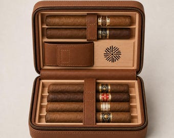 May include: A brown leather cigar travel case with a zipper closure, containing six cigars held in place by leather straps. The interior features a light wood lining, a small leather pouch, and a circular ventilation grate with a sunburst pattern.
