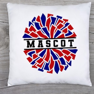 May include: White square pillow with a red, blue, and black pom-pom design. The word "MASCOT" is printed in bold black letters across the center of the pom-pom. The pillow is likely a decorative item.