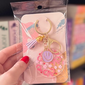 Pink Bow & Purple Smiley Face Acrylic Keychain with Gold-Tone Keyring, Purple Tassel and Smiley Face Charm