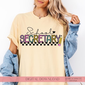 May include: A pale yellow t-shirt featuring the text School SECRETARY in black, purple, teal, and yellow lettering. The design includes a small black heart, a yellow pencil graphic, and a black and white checkered pattern along the bottom edge.